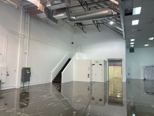 A large empty building with stairs leading up to the second floor