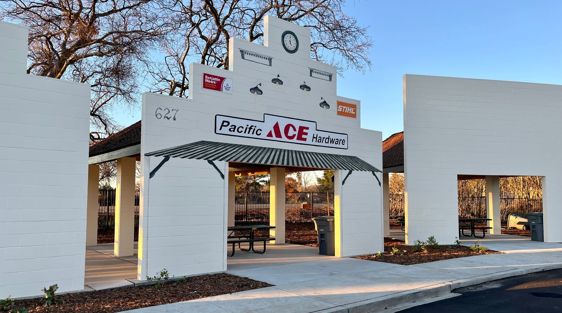 A white building with a sign that says pacific ace on it.
