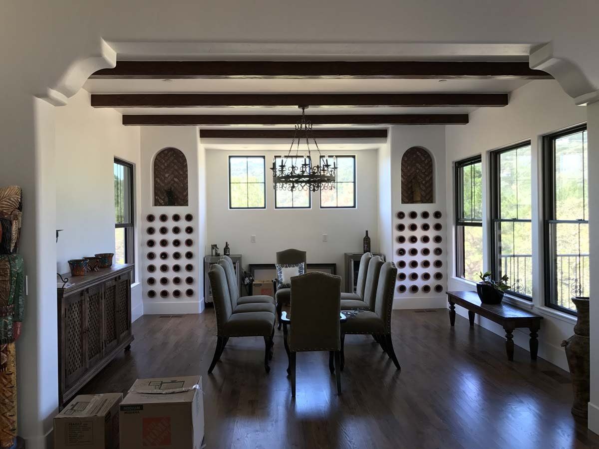 A dining room with a table and chairs and a chandelier