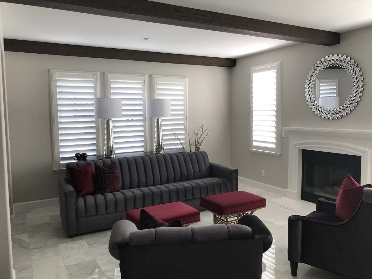 A living room with a couch , chairs , and a fireplace.