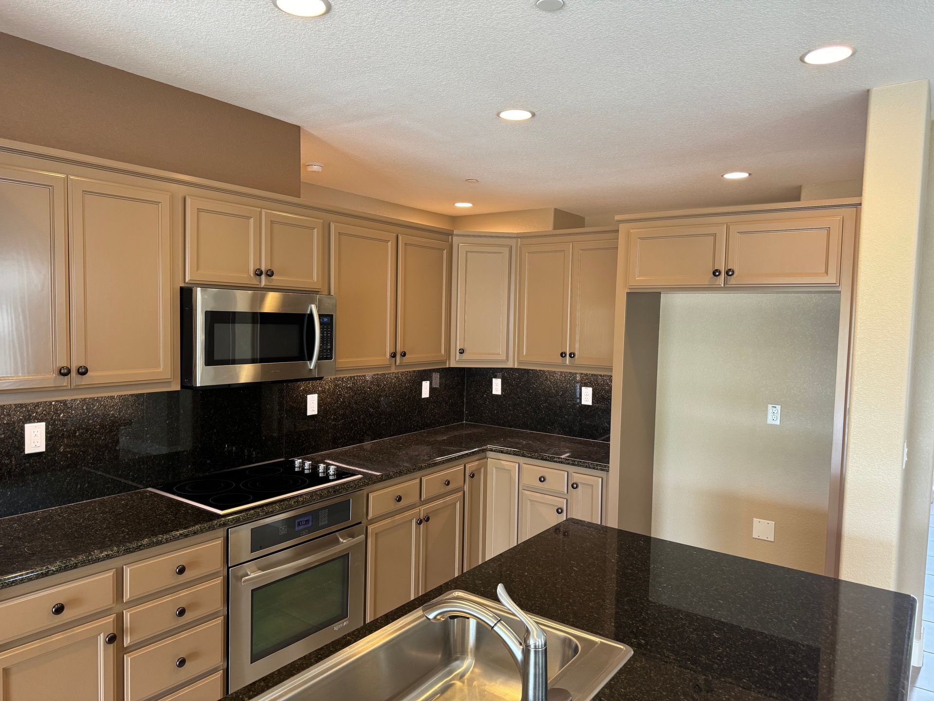 A kitchen with stainless steel appliances and granite counter tops