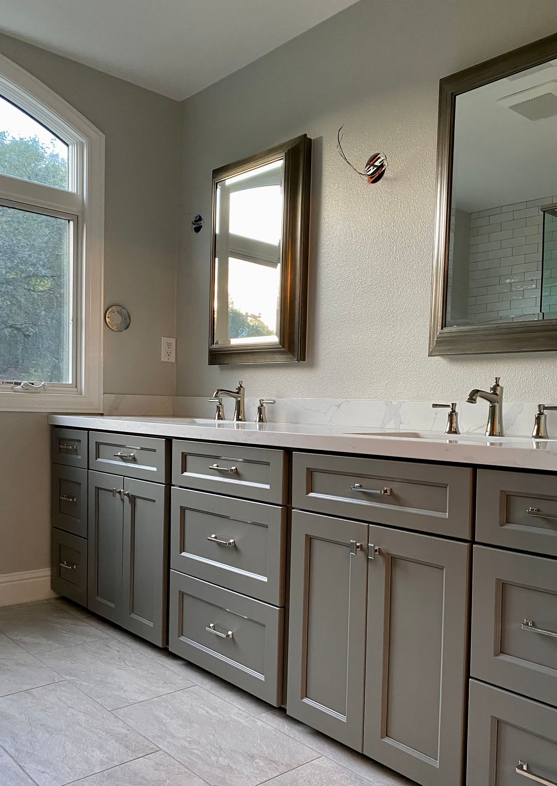 A bathroom with two sinks and a mirror