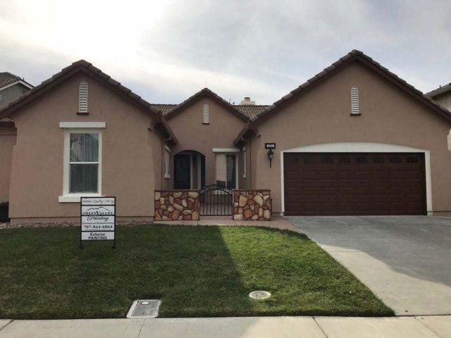 A house with a for sale sign in front of it