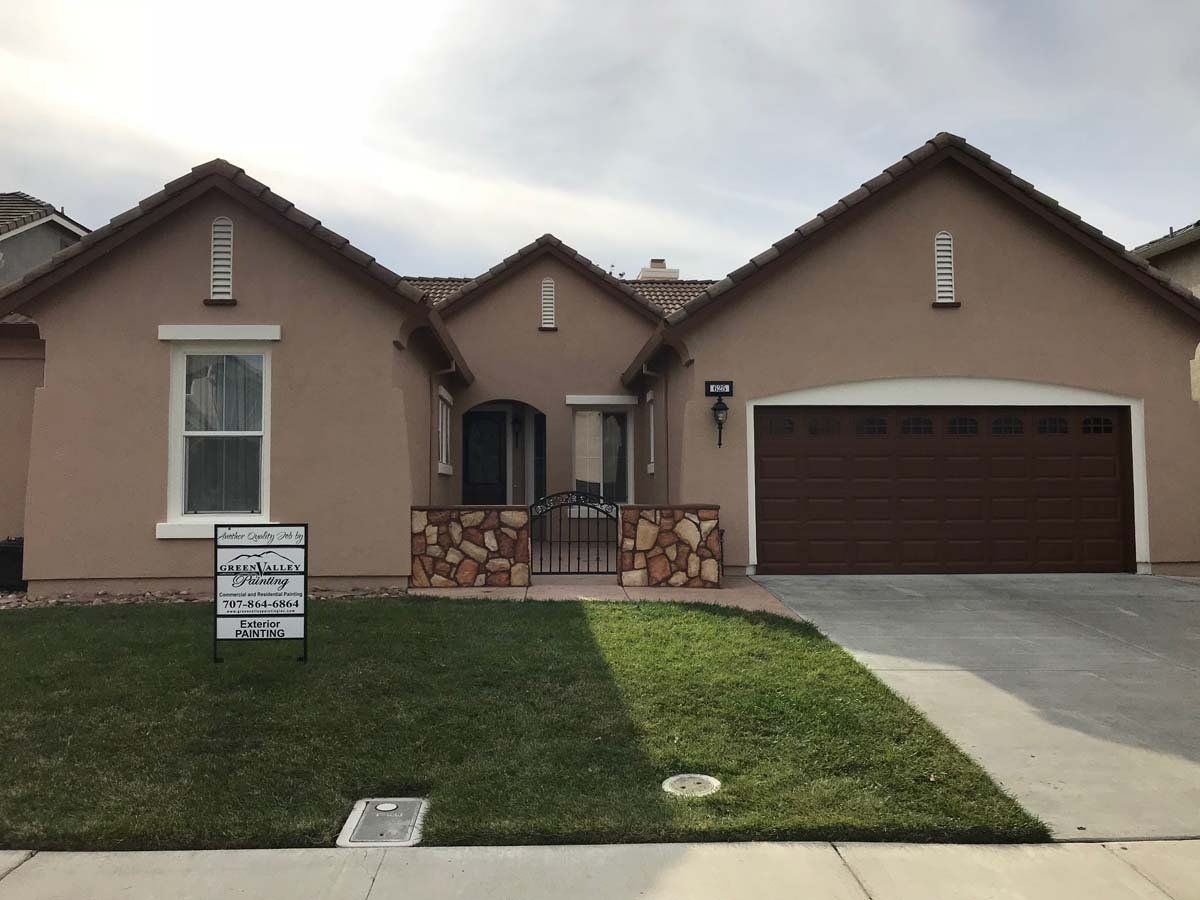 A house with a for sale sign in front of it