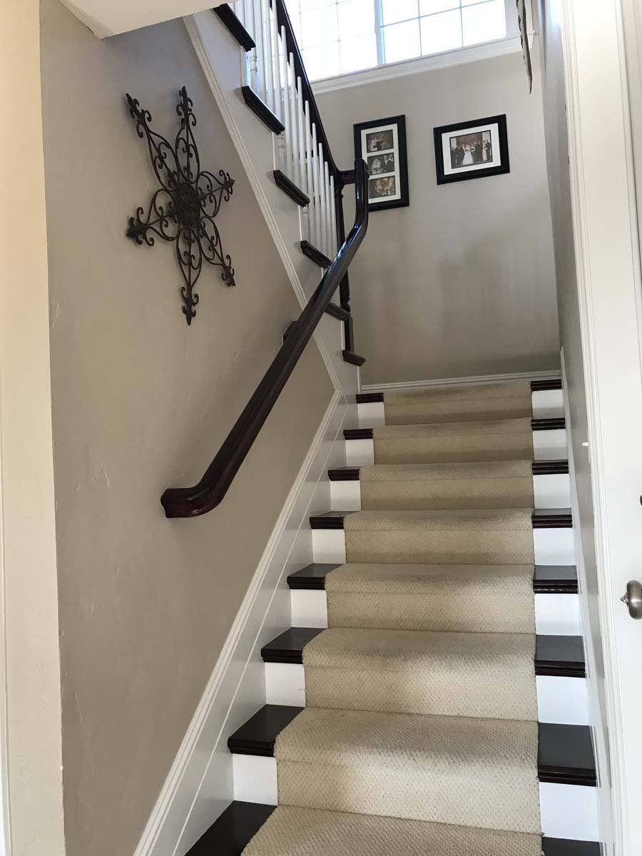 A staircase with black and white steps and a star on the wall