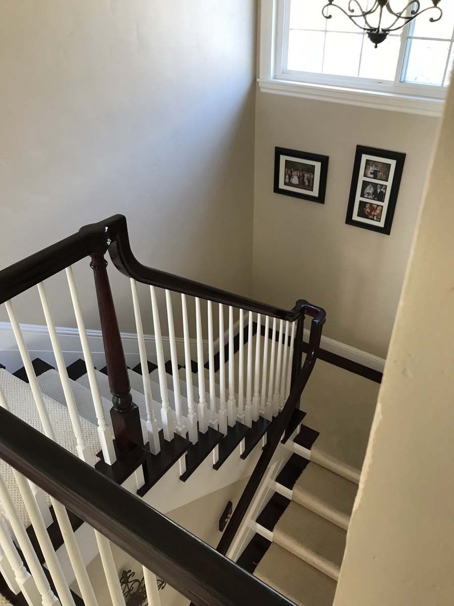 A view of a staircase from the top of the stairs.