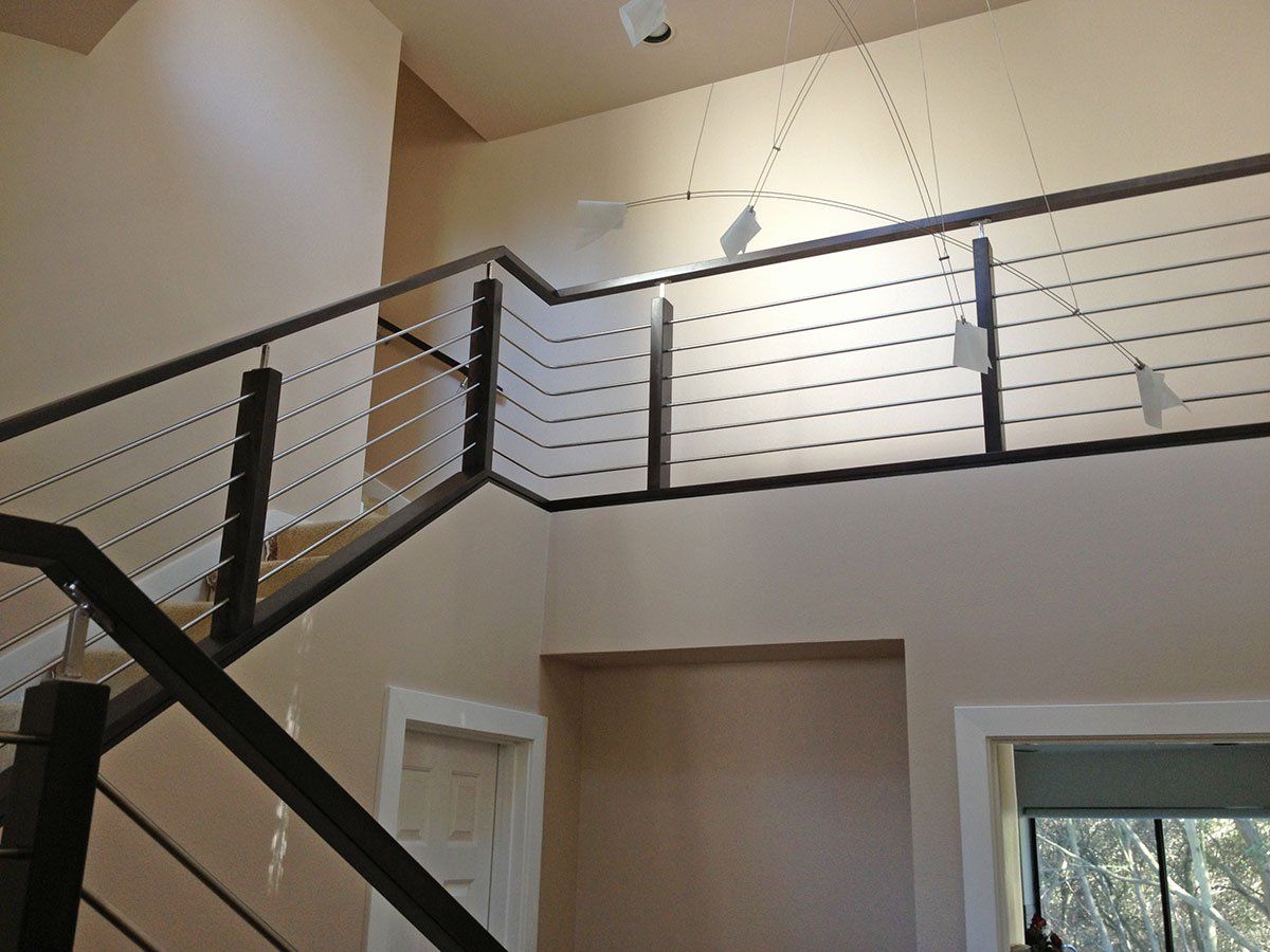 A staircase with a metal railing leading up to the second floor