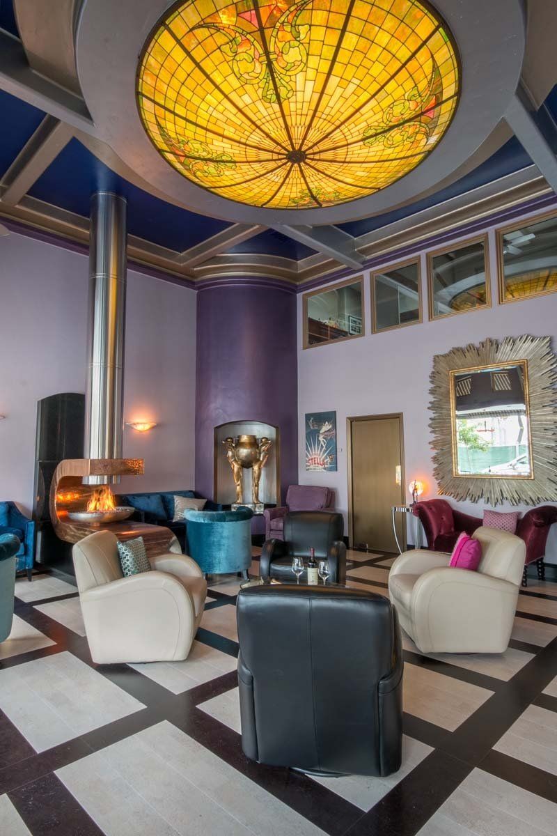 A living room with a stained glass ceiling and a fireplace