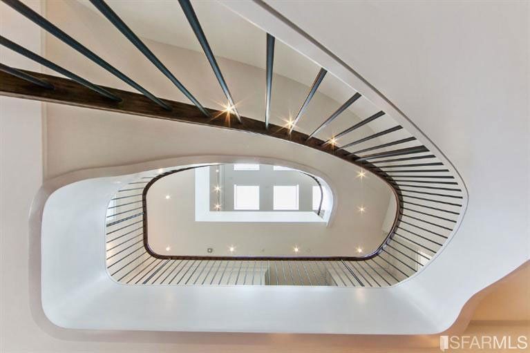 Looking up at a spiral staircase in a building