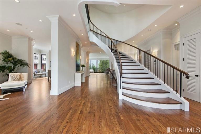 There is a curved staircase in the middle of the room.