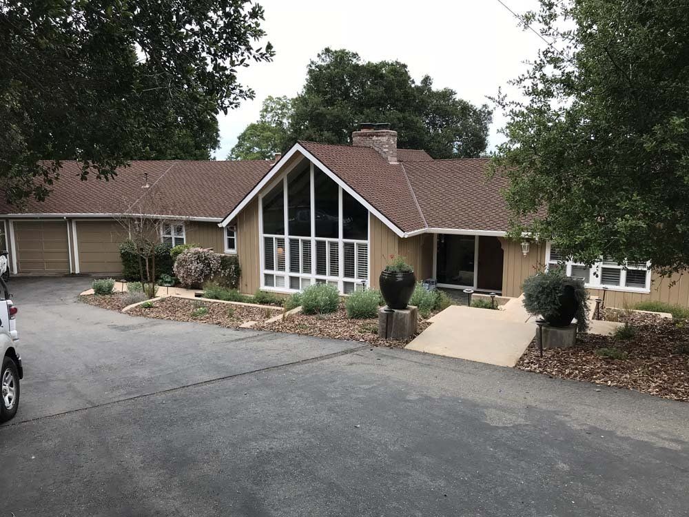 A large house with a car parked in front of it