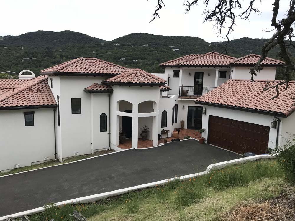 A large white house with a red tile roof