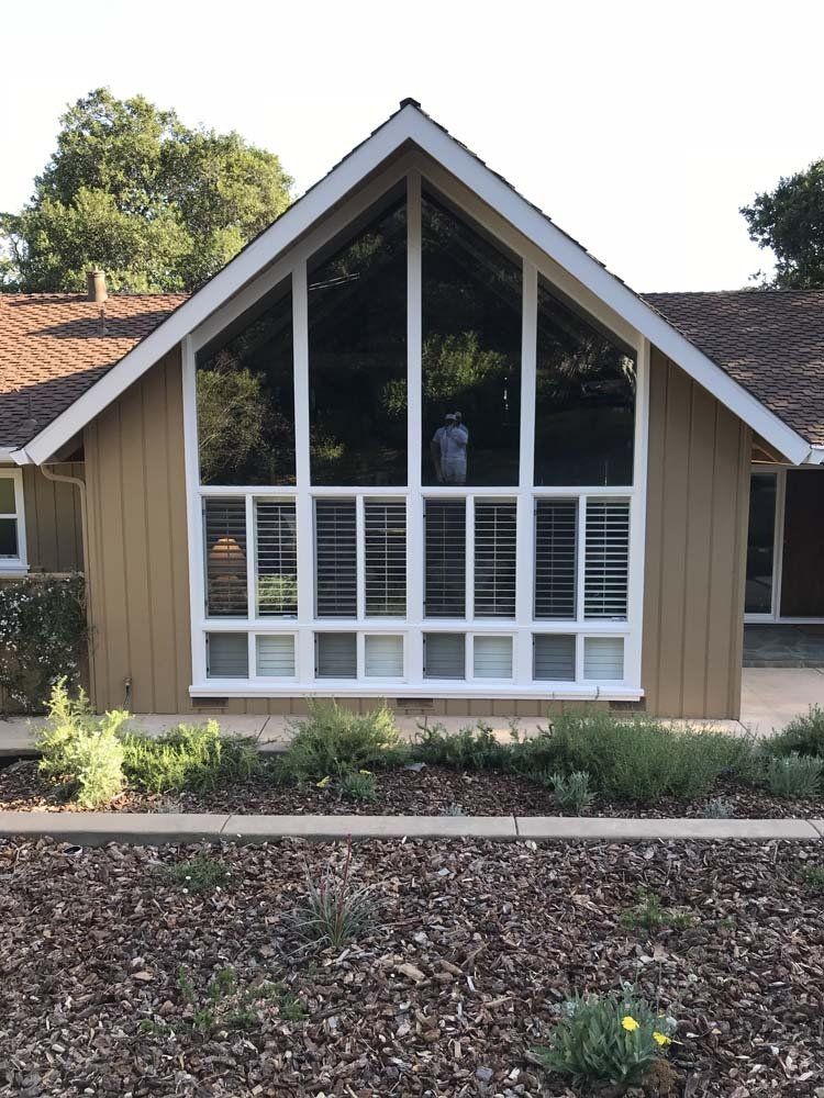 A house with a vaulted roof and lots of windows