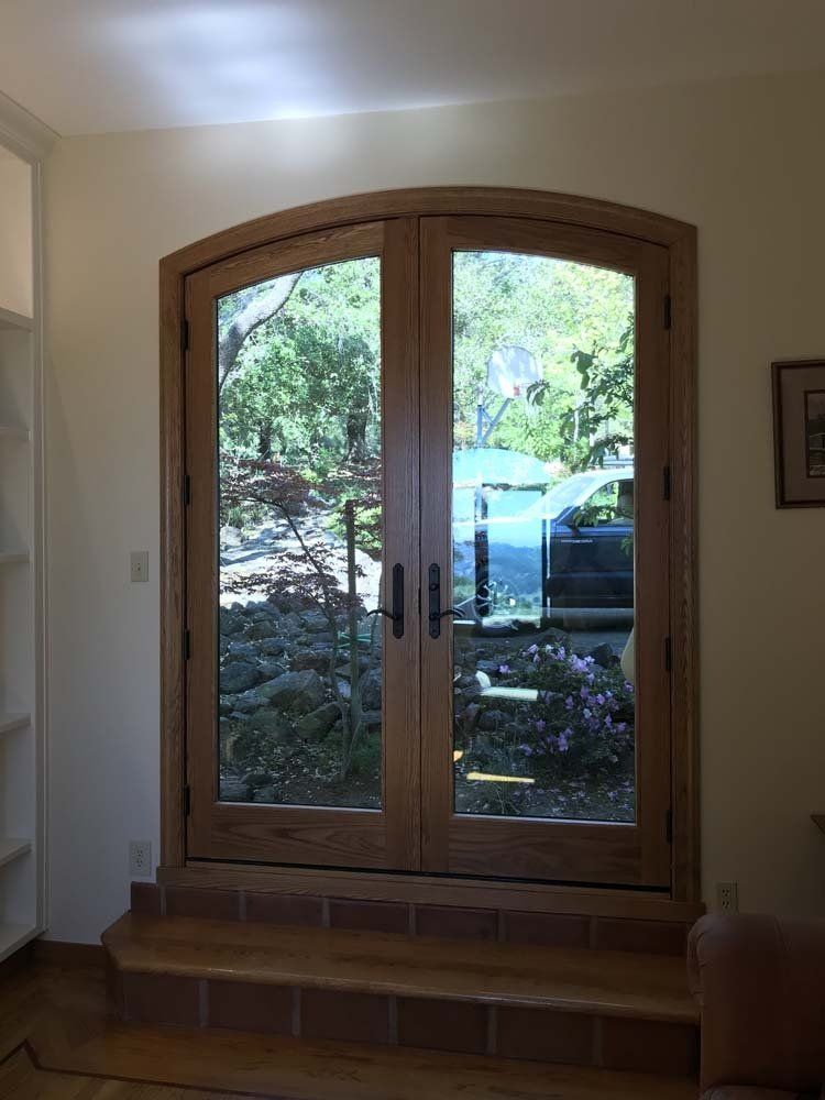 A room with a large window and a picture on the wall