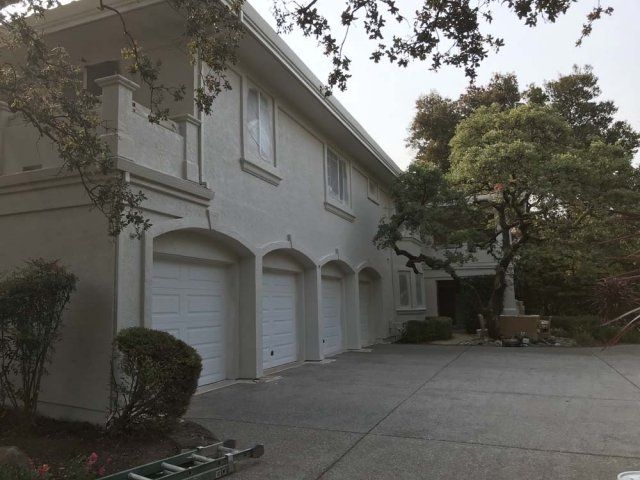 A white house with a ladder in front of it