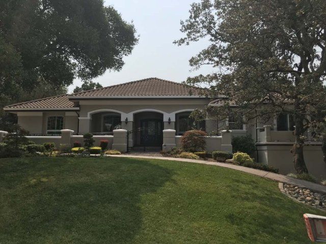 A house with a large lawn in front of it