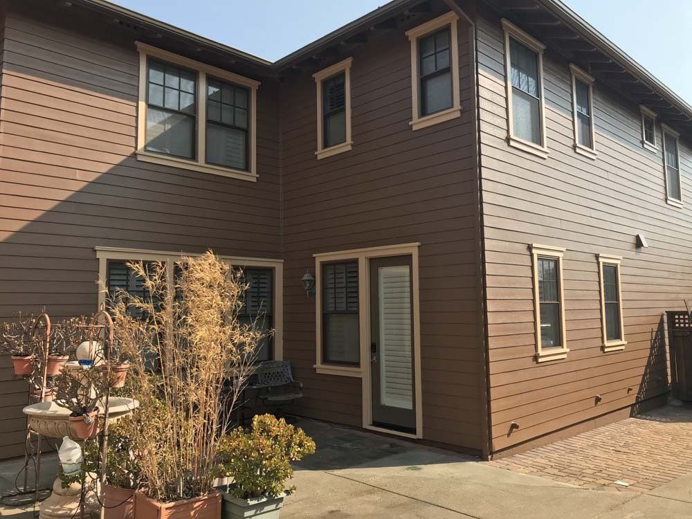 A brown house with a lot of windows and a door