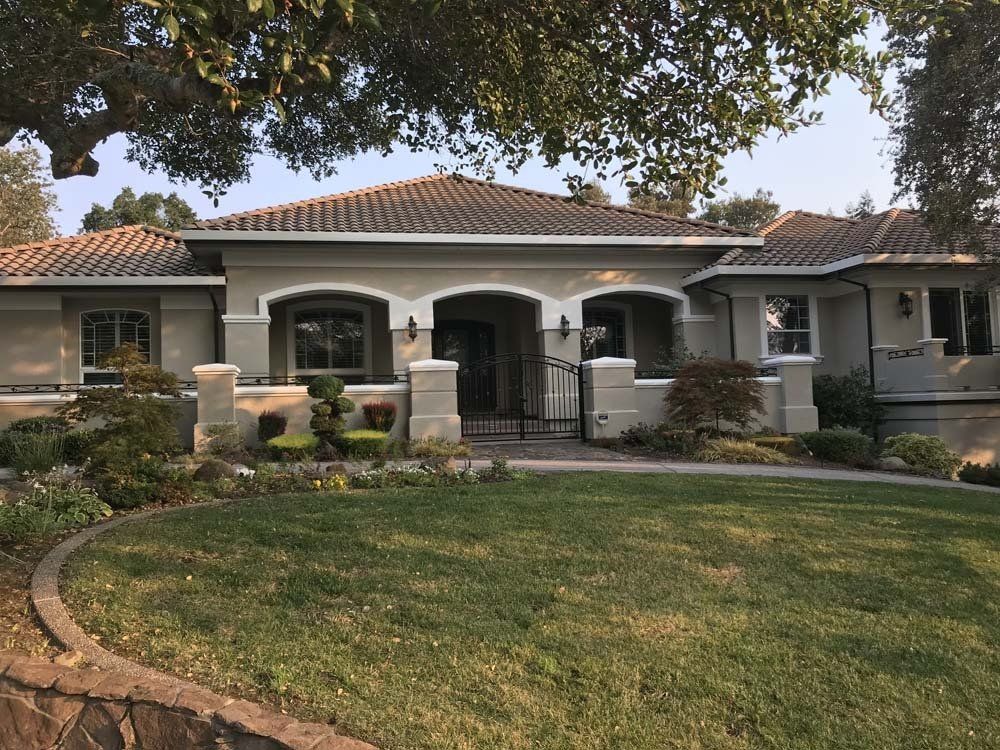 A large house with a lush green lawn in front of it