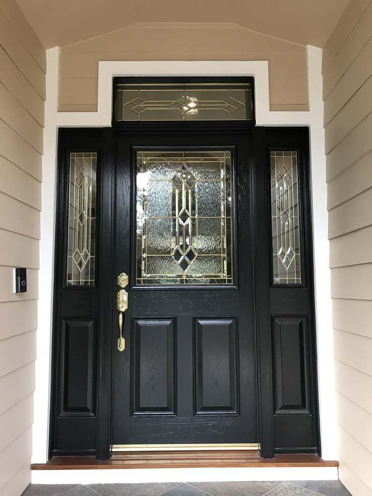 A black front door with a stained glass window