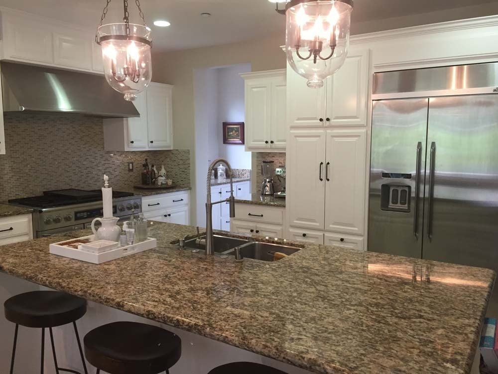 A kitchen with granite counter tops and stainless steel appliances