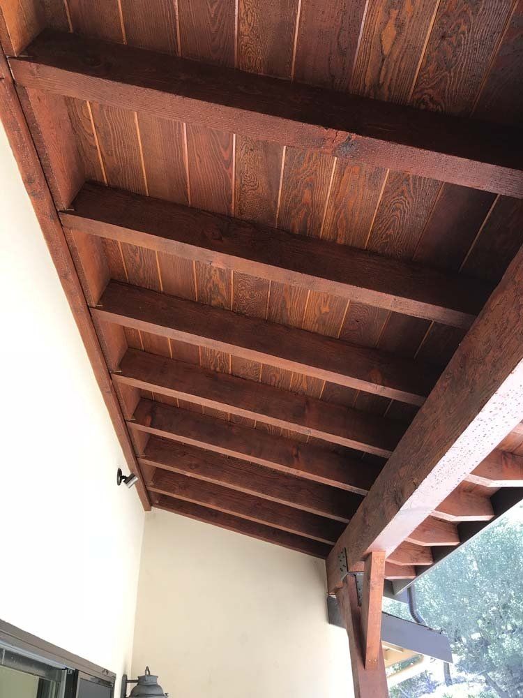 A close up of a wooden ceiling on a porch.
