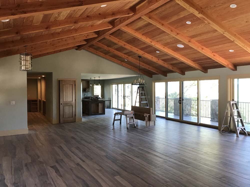 A large empty room with a wooden ceiling and lots of windows.