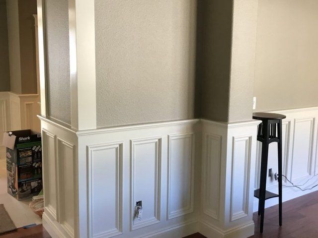 There is a stool in the corner of the room.