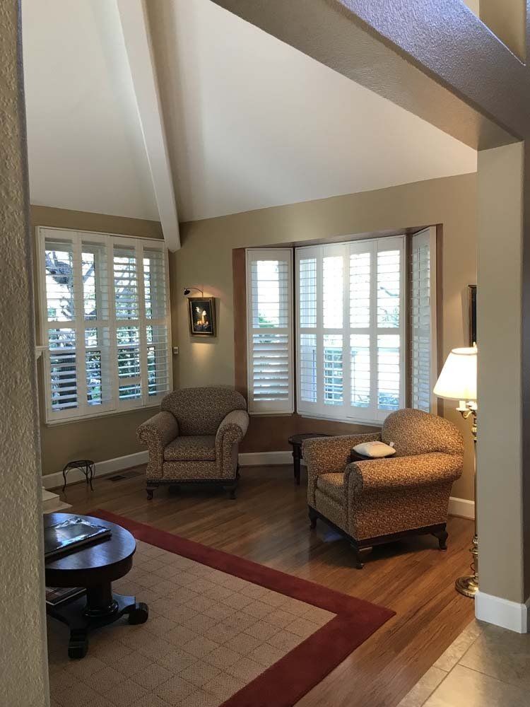 A living room with two chairs and a table