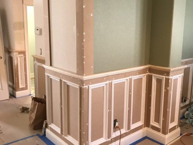 A room with a corner that is being painted