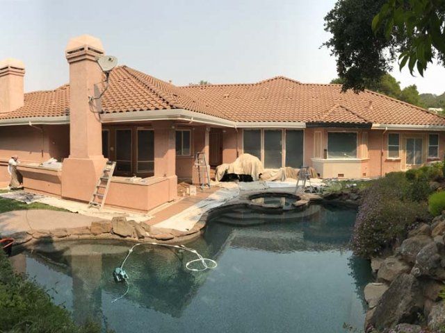 A large house with a pool in front of it