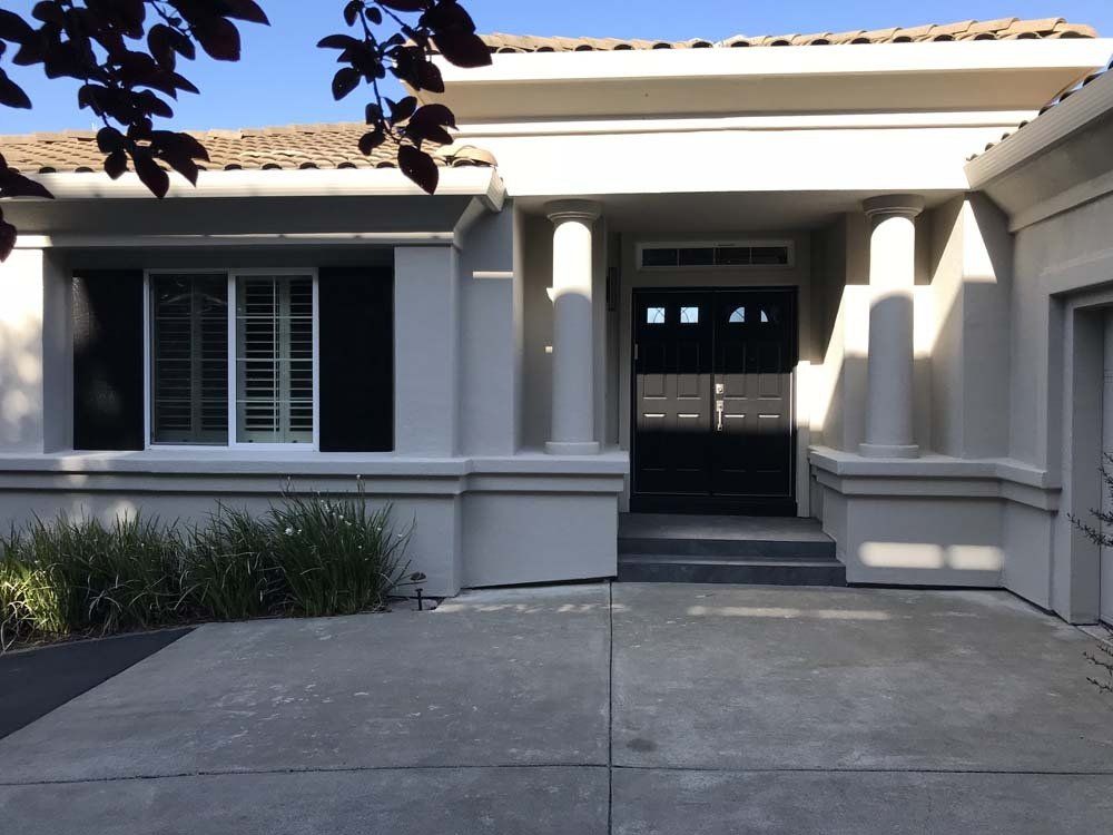 A white house with black shutters on the windows