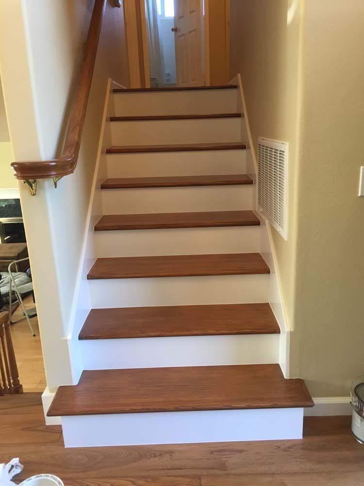 A staircase with wooden steps and white steps in a house.