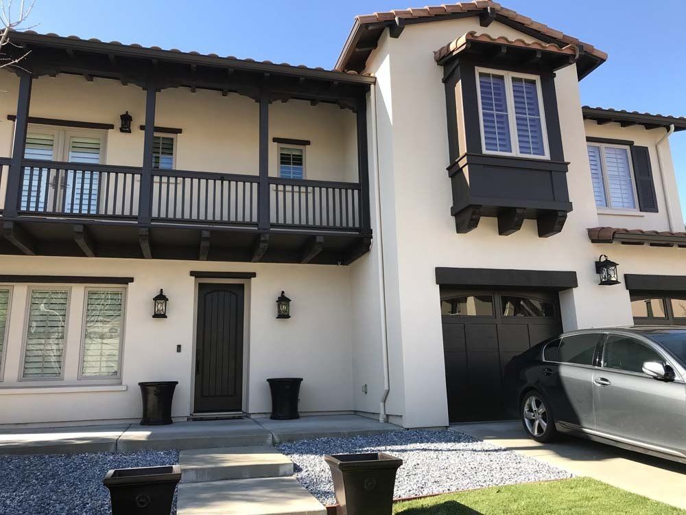 A large white house with a car parked in front of it