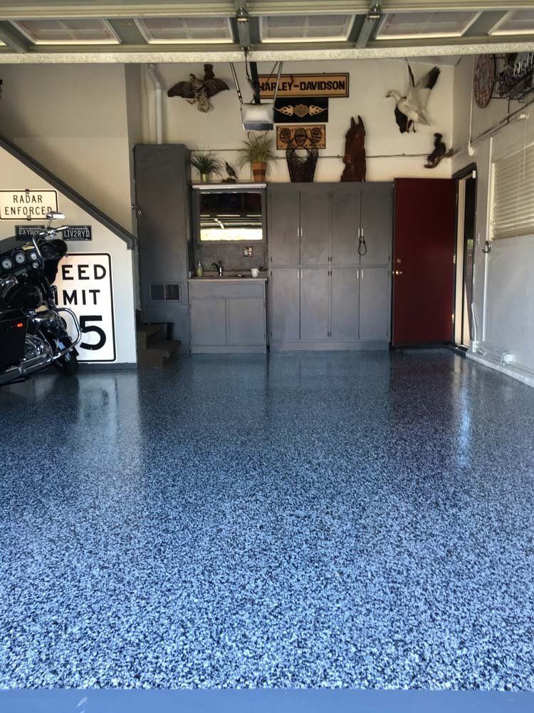 A motorcycle is parked in a garage with a sign that says feed mit 5