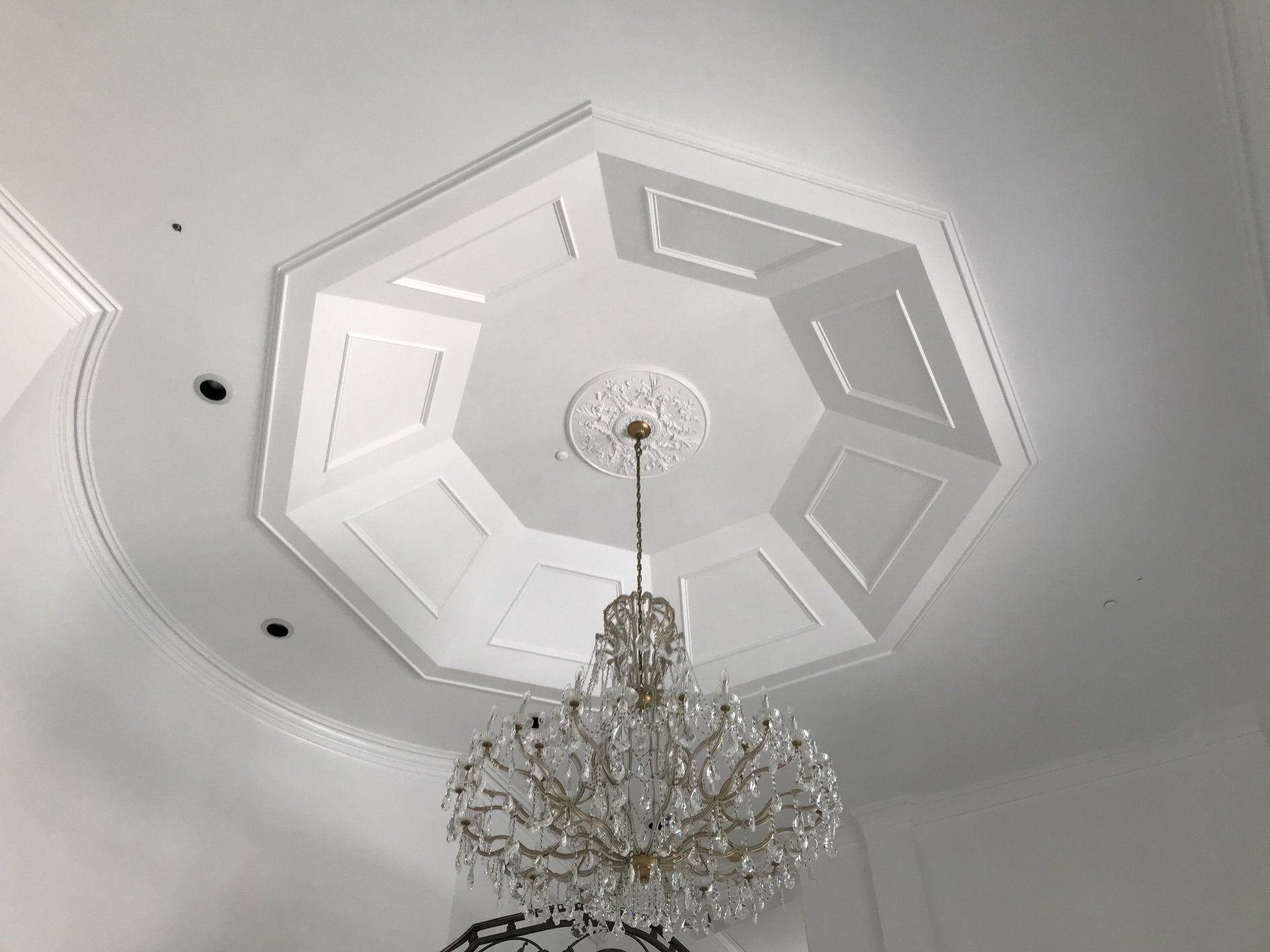 A chandelier is hanging from the ceiling of a room