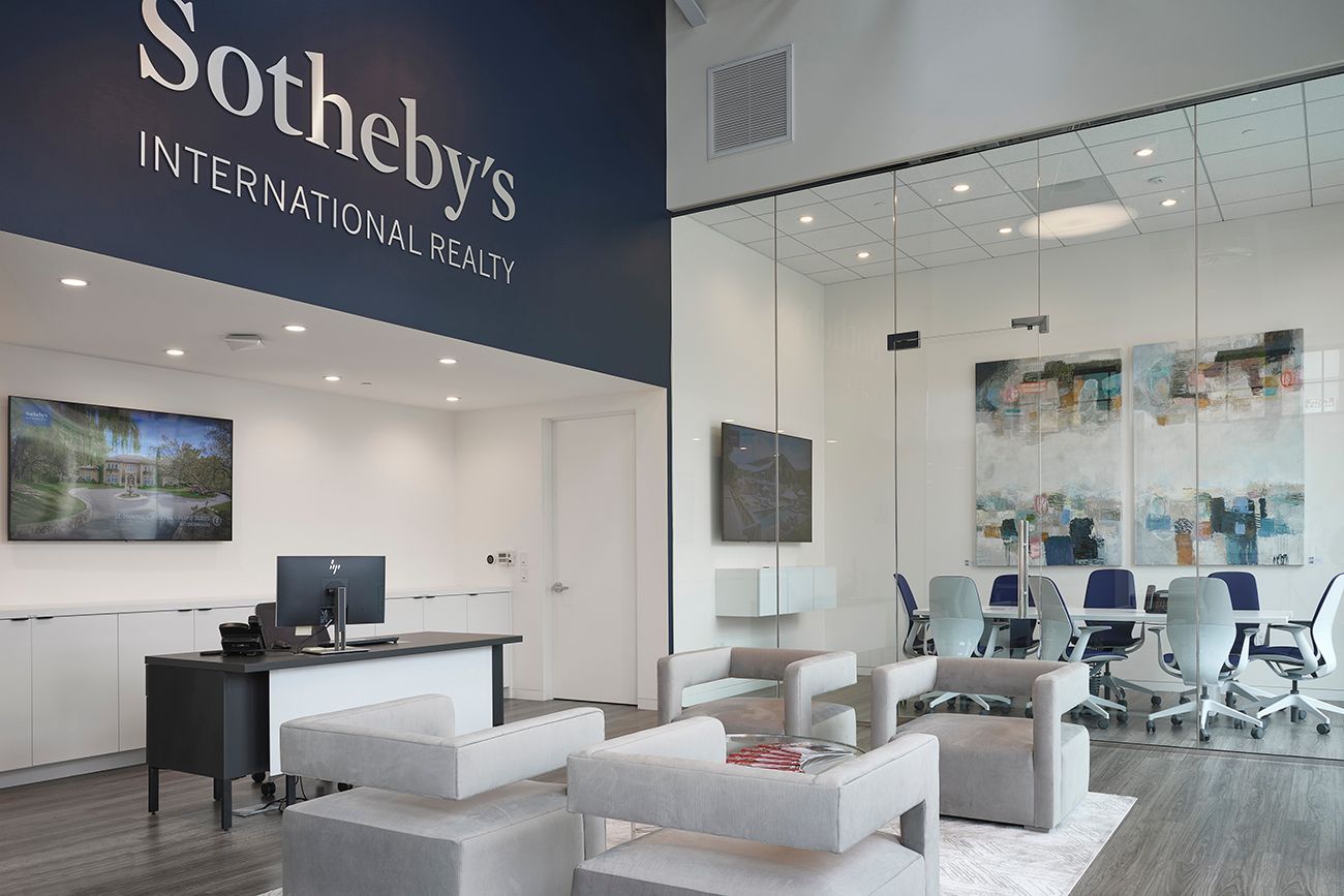 A sotheby 's office with a large sign above the entrance