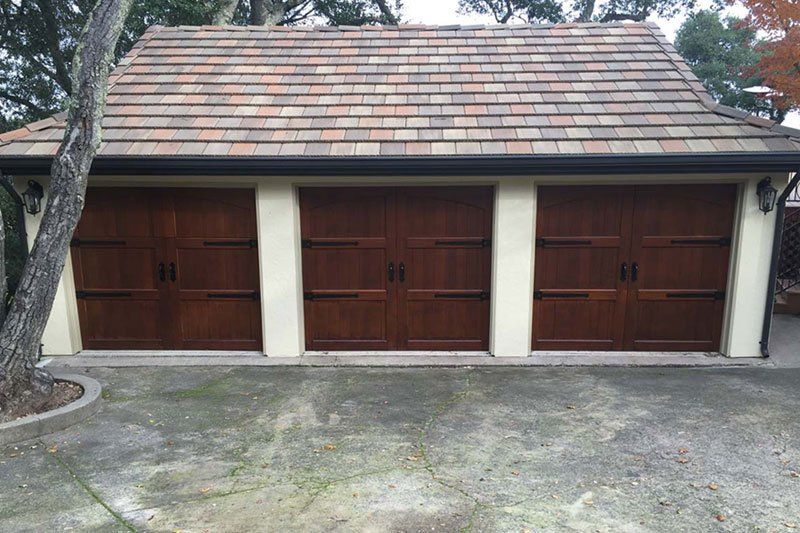 A garage with wooden doors and a tiled roof