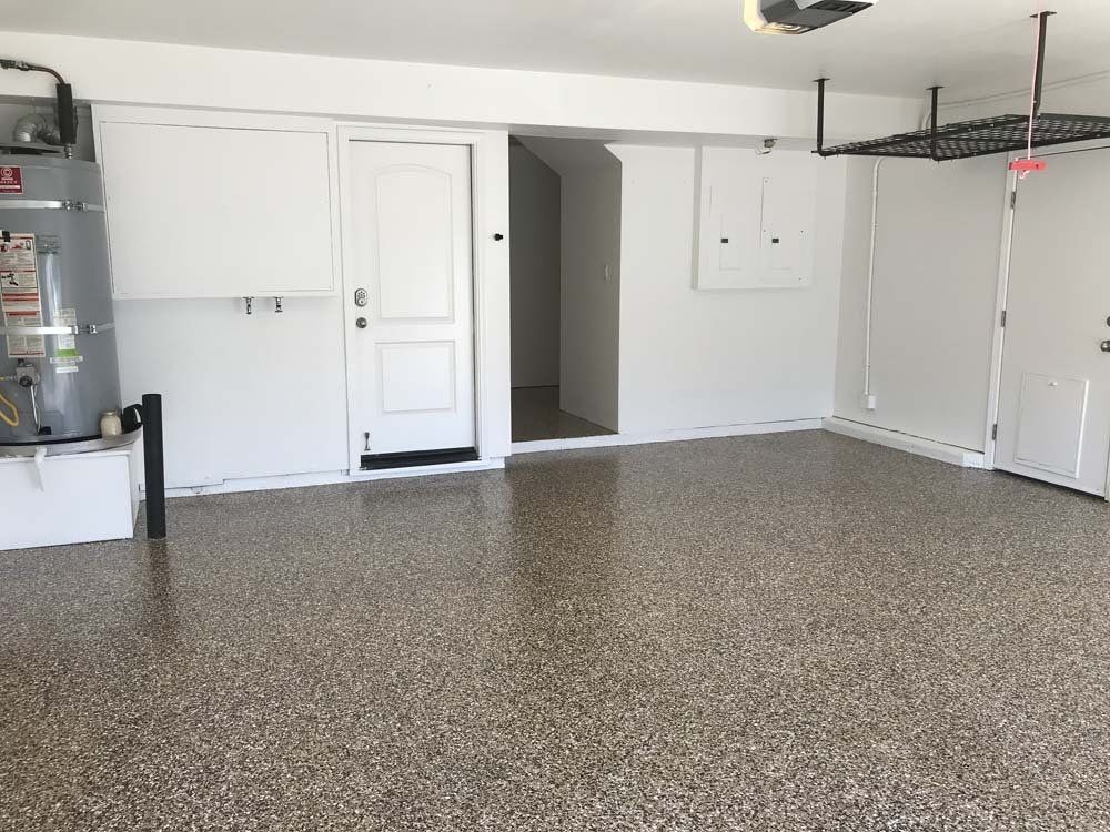 An empty garage with a heater and a door