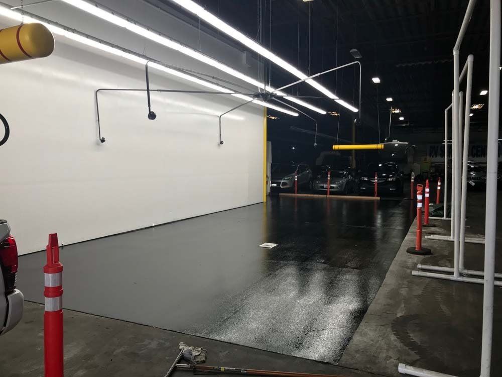 A parking lot with cars parked in it at night