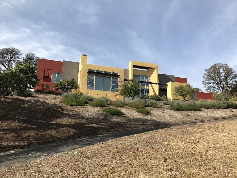 A large colorful house is sitting on top of a hill