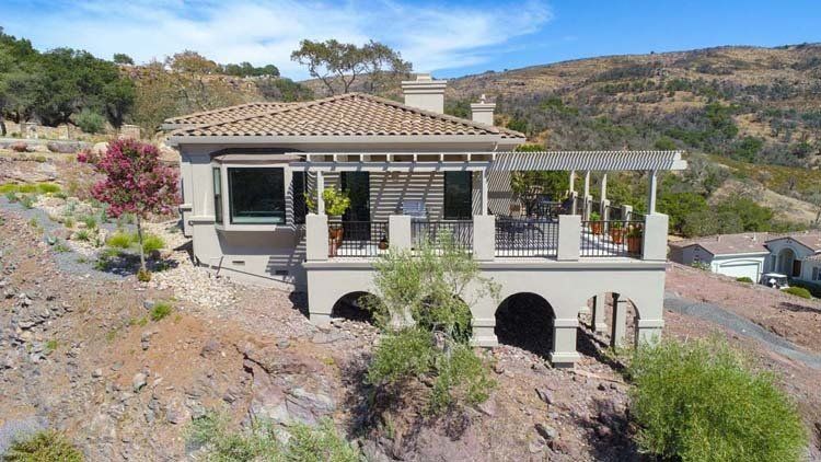 An aerial view of a large house on top of a hill.