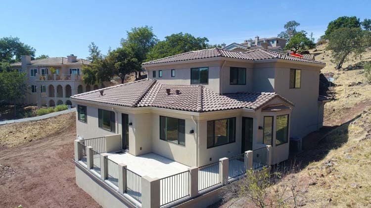 An aerial view of a large house on a hill.