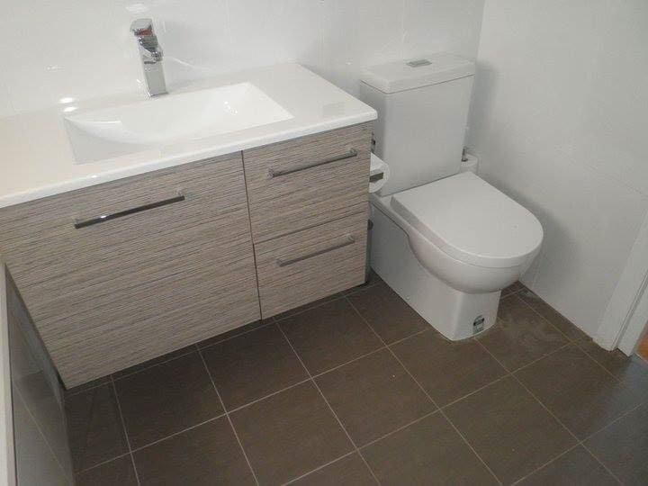 A Bathroom with a Sink, Toilet and Drawers — Illawarra Bathrooms in Wollongong, NSW