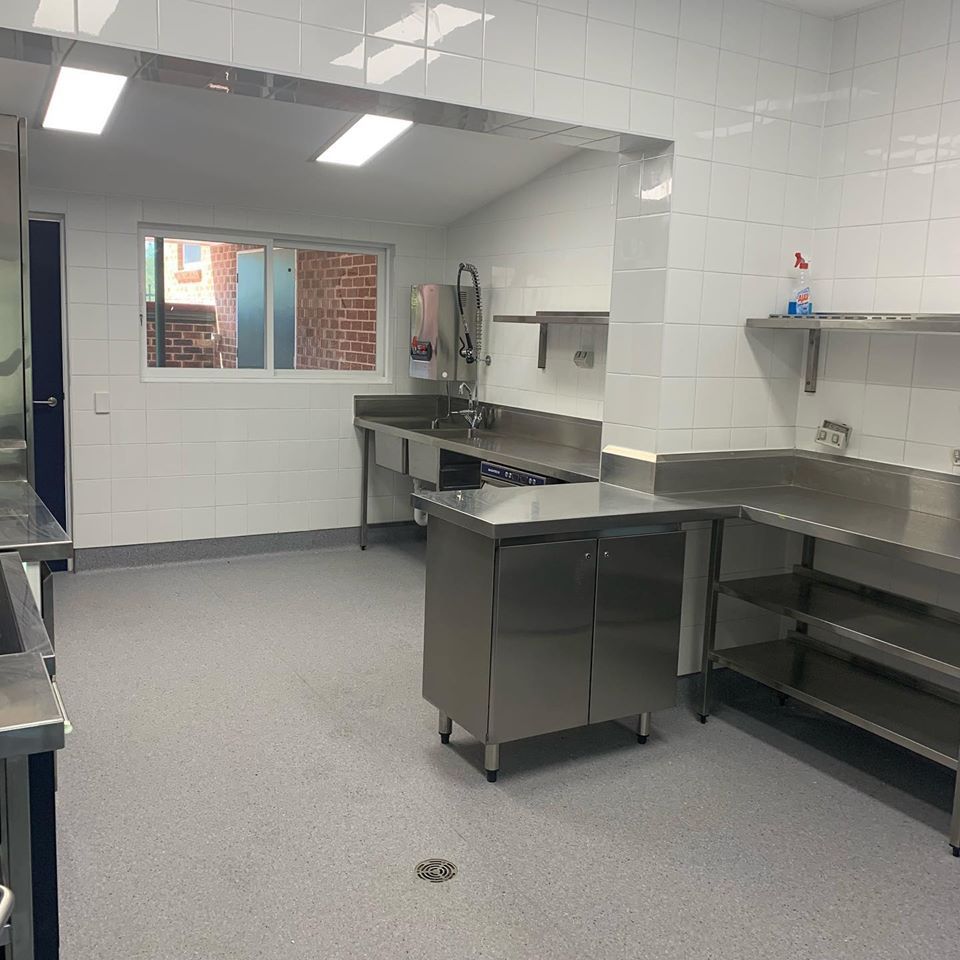 A Kitchen with Stainless Steel Appliances and a Sink — Illawarra Bathrooms in Wollongong, NSW