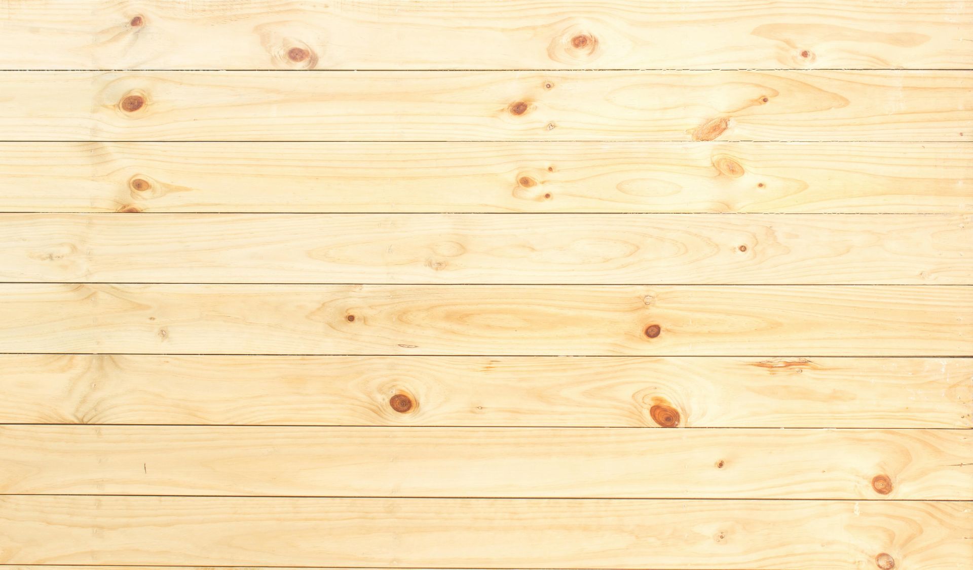 Light-colored wooden planks arranged horizontally, with visible knots.