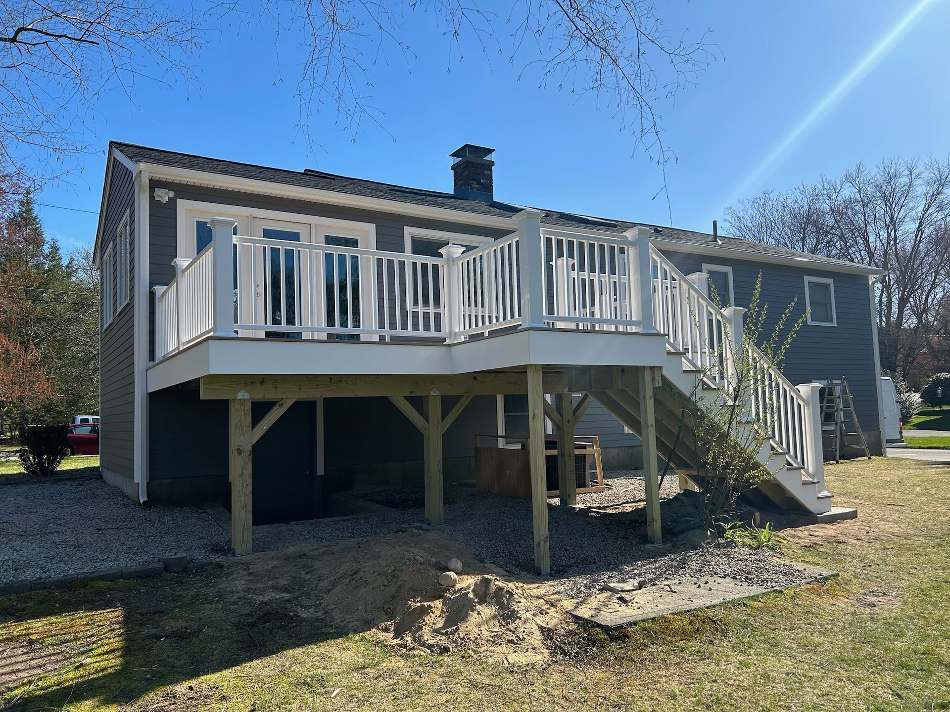 A renovated patio deck on the back of a house in shrewsbury mass