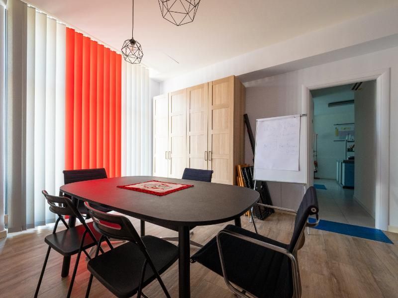 Una sala conferenze con tavolo, sedie e lavagna.