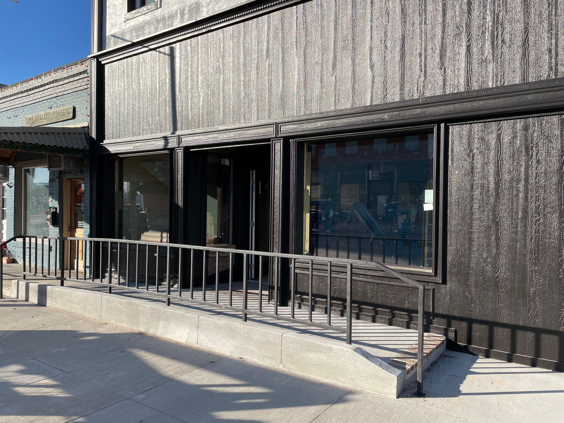 A building with a ramp leading to the front door.