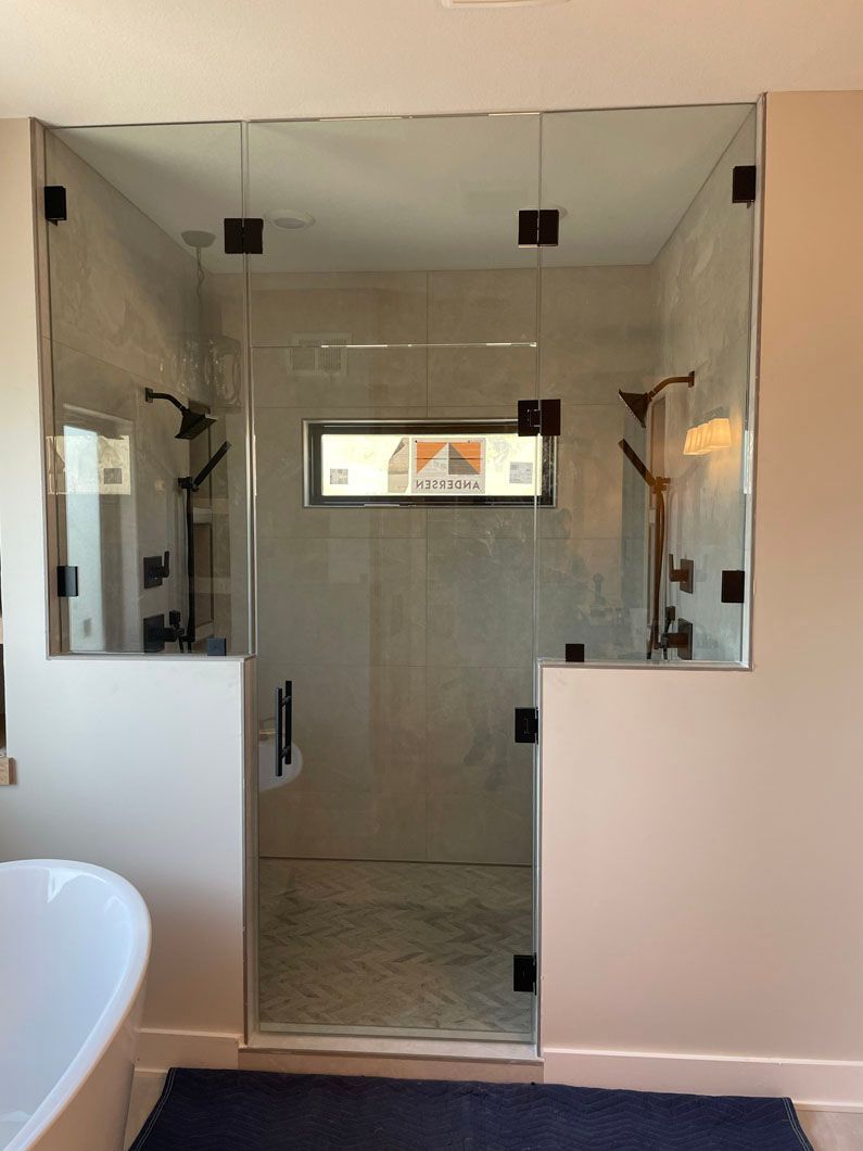 A bathroom with a walk in shower and a bathtub.