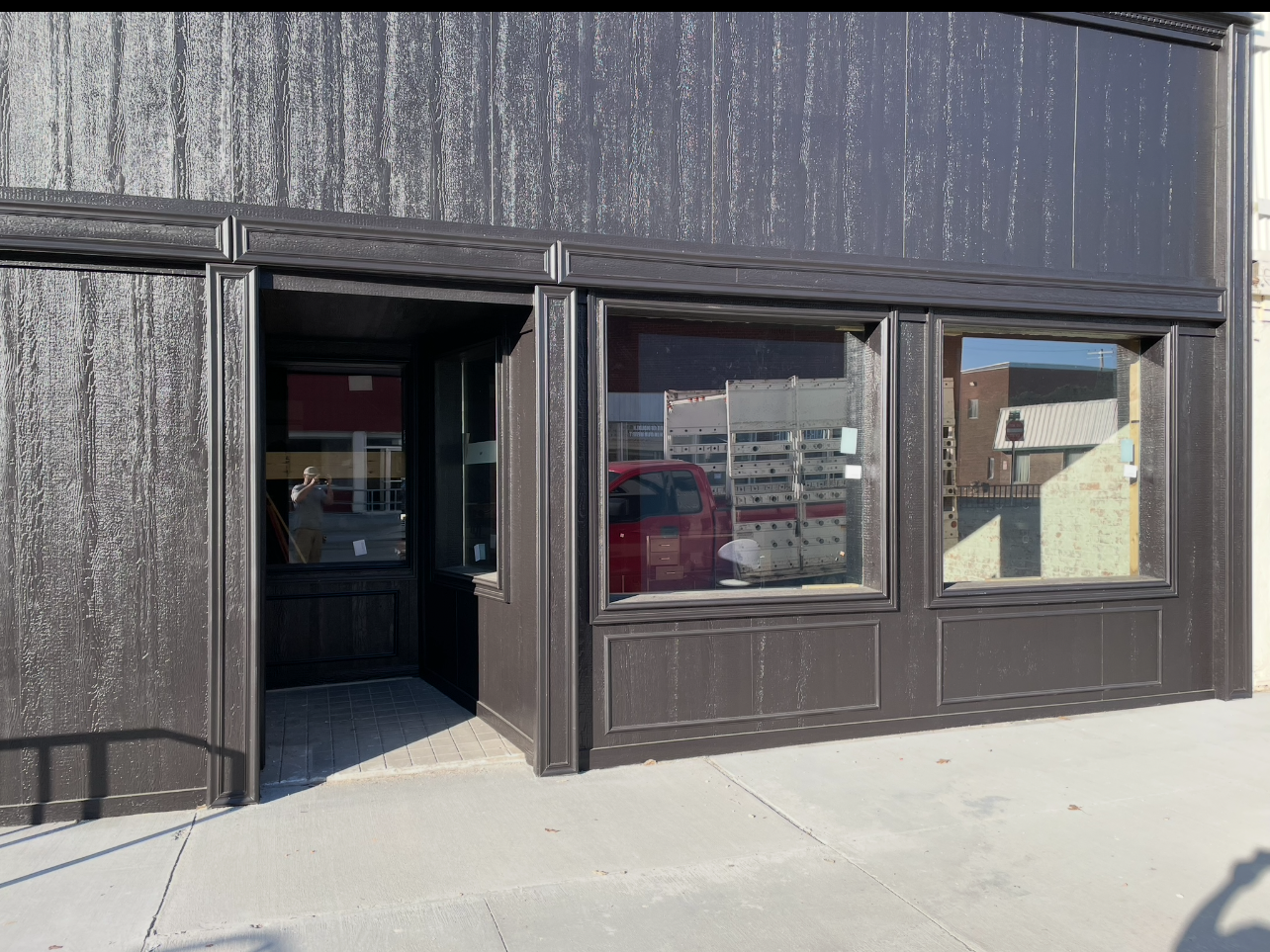 A black building with a lot of windows and a door